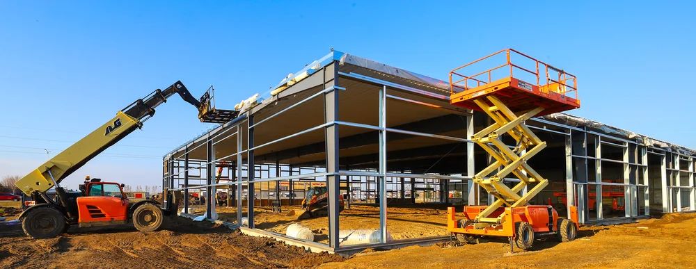 Crane erecting red-iron rigid steel frames for a commercial building