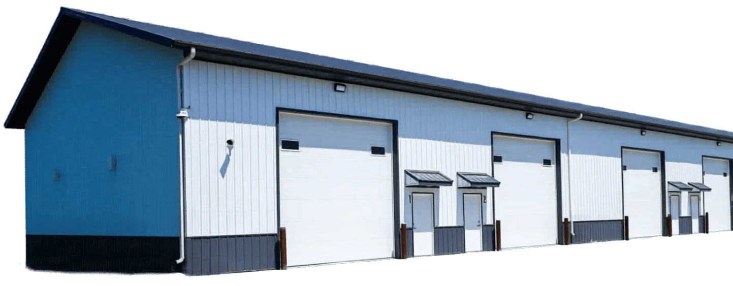 A long blue-and-white post-frame storage building with multiple overhead doors