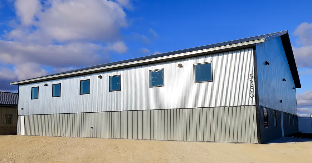 Commercial post-frame shop building with metal siding and shed-style roofline