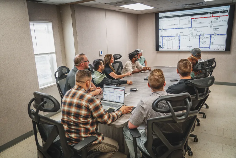The Century crew reviewing building plans together